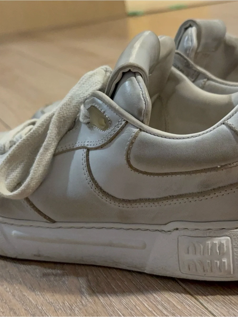 Miu Miu Off-White Leather Sneakers with Gold Trim